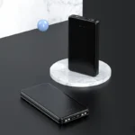 Elegant black power bank on marble, ideal for modern professionals seeking style and efficiency.