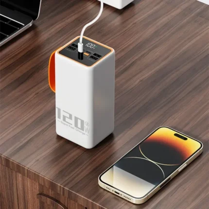Sleek white power bank with orange accent next to smartphone, ideal for modern professionals.