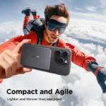 Skydiver in red jumpsuit taking a thrilling selfie with smartphone against a vibrant blue sky.